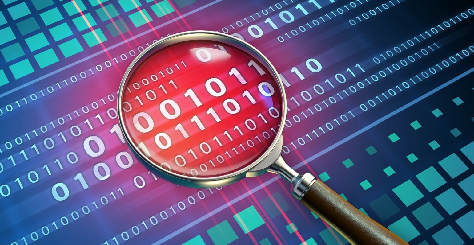 magnifying glass looking at binary code