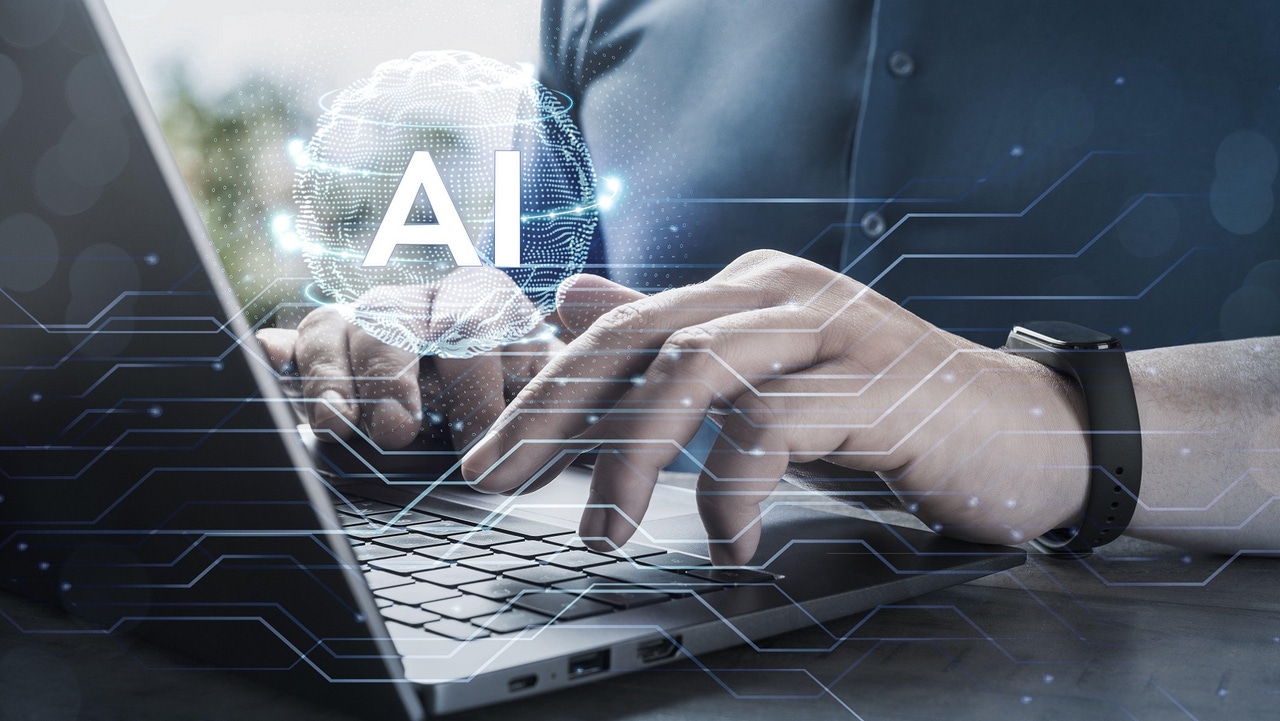 person typing on a keyboard with "AI" hovering over the keyboard person typing on a keyboard with "AI" hovering over the keyboard