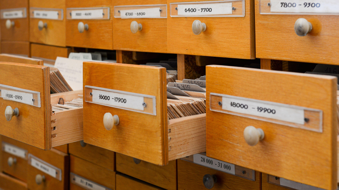 3 wooden crates open in a library 3 wooden crates open in a library