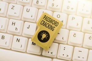 Text caption presenting Password Cracking on a button on top of a keyboard