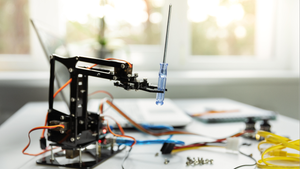 robot arm and laptop on the table robot arm and laptop on the table