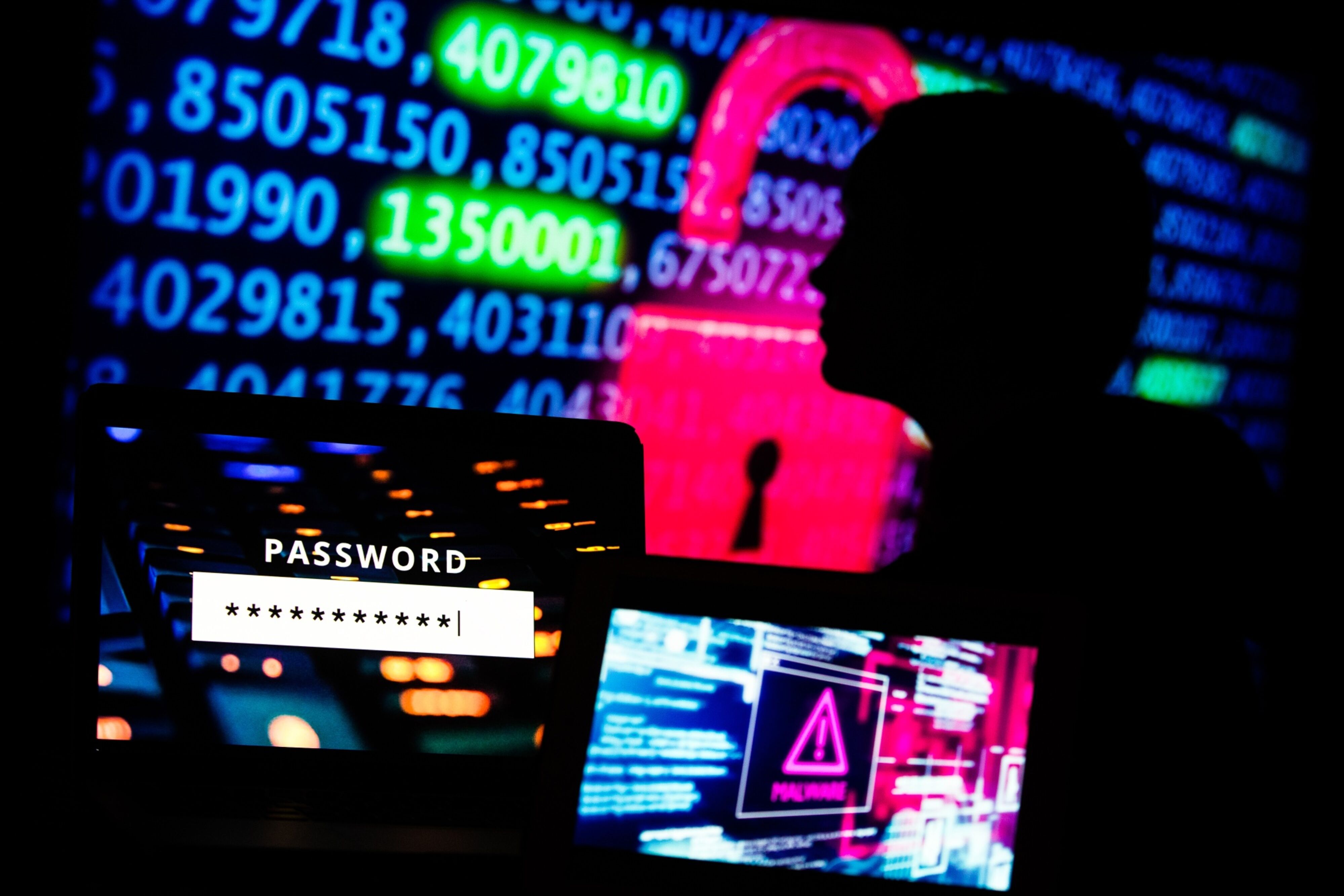 silhouette in a dark room with cybersecurity incident