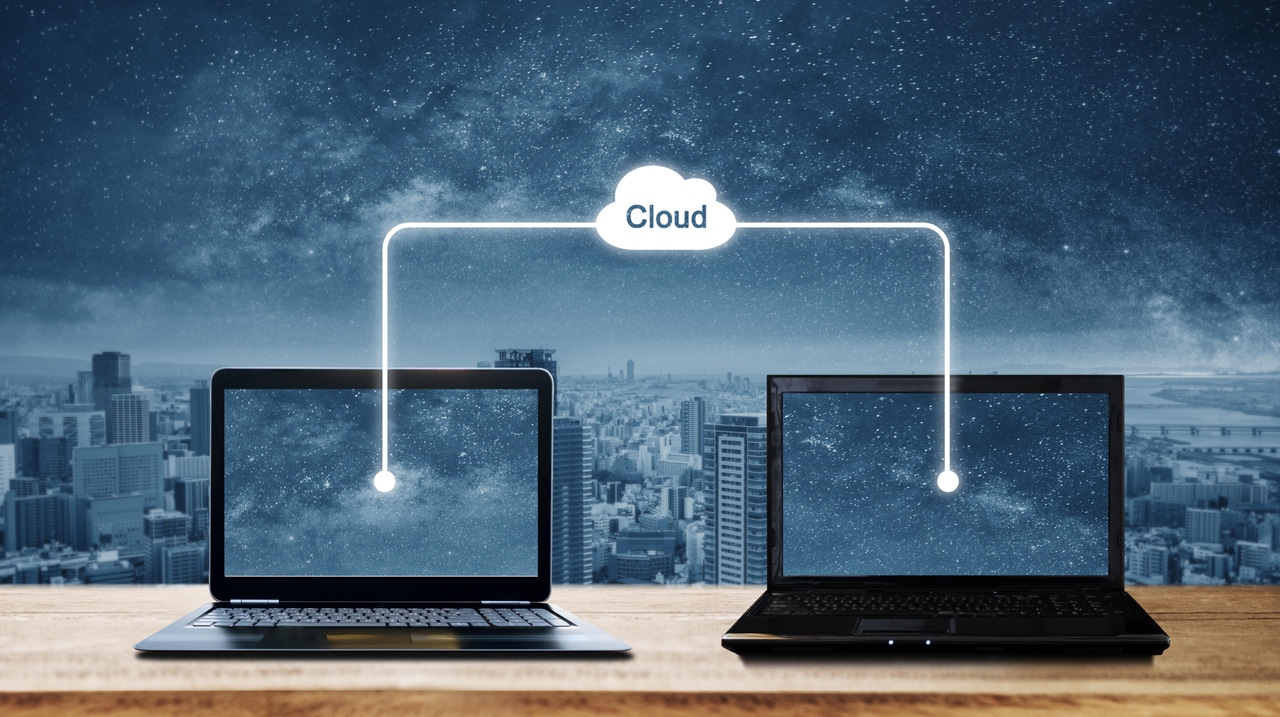 Computer laptops sharing data through cloud storage Computer laptops sharing data through cloud storage