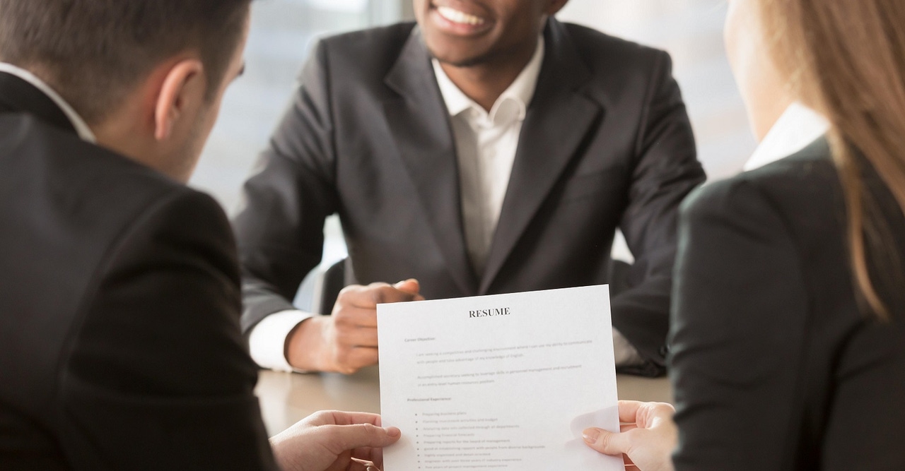 HR managers examining a resume HR managers examining a resume