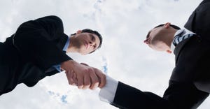 2 businessmen shaking hands with clouds overhead