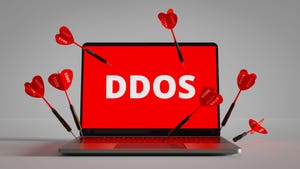 a laptop with the text DDoS on the screen and darts labeled DDoS stuck in the keyboard