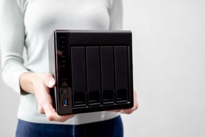 A person holding a NAS appliance A person holding a NAS appliance