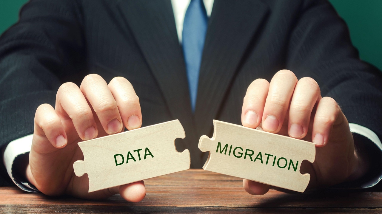 two pieces of a puzzle with "data" and "migration" on them being placed together two pieces of a puzzle with "data" and "migration" on them being placed together