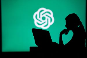 Silhouette of person in front of ChatGPT logo Silhouette of person in front of ChatGPT logo