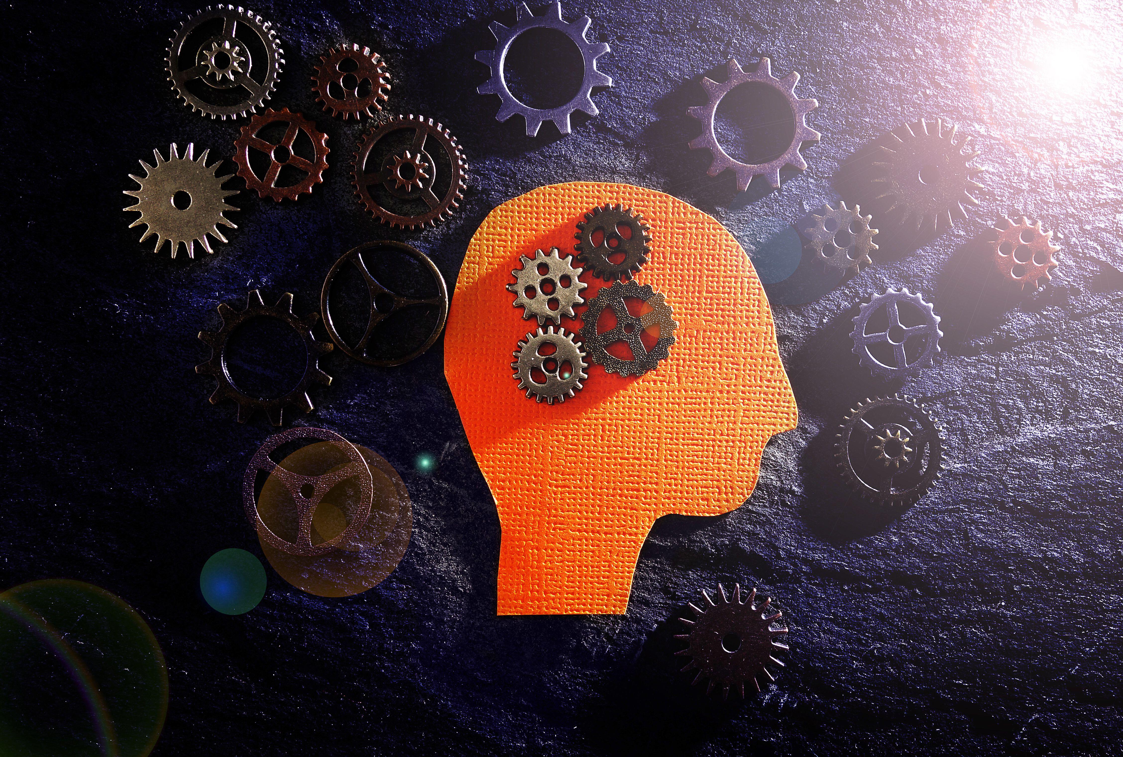 head figure with gears on textured surface