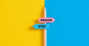 "resign" and "stay" signs attached to a pencil "resign" and "stay" signs attached to a pencil