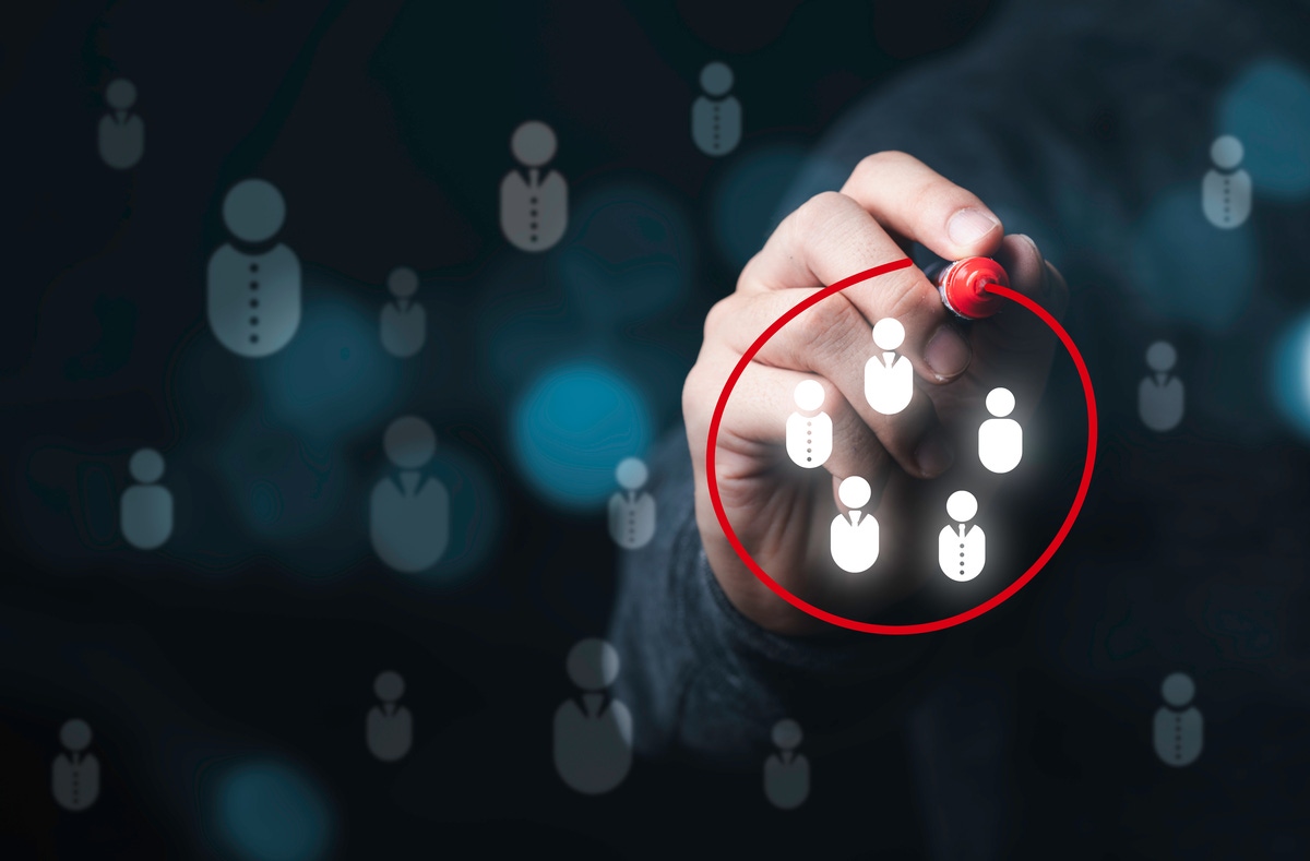 hand circling people icons in red marker hand circling people icons in red marker