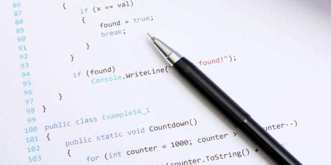 White paper with code and numbers on it mechanical pencil laying across