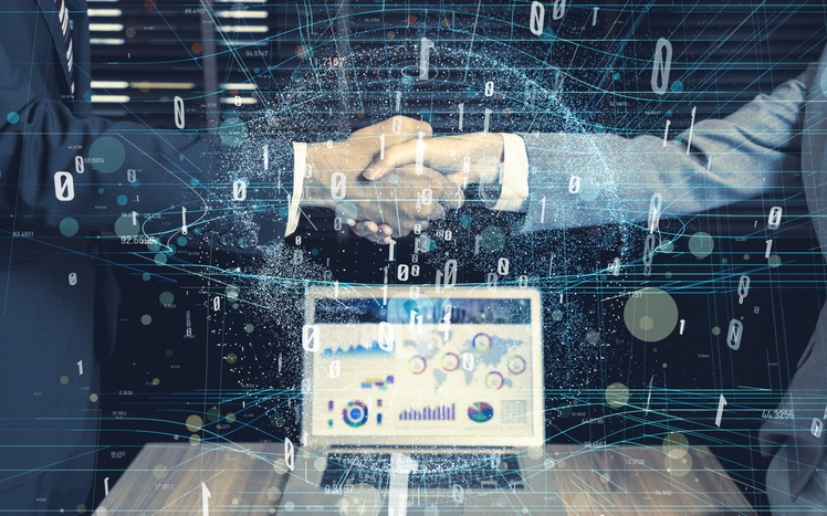 two businessmen shake hands to signal tech deal