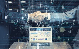 two businessmen shake hands to signal tech deal two businessmen shake hands to signal tech deal