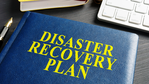 disaster recovery playbook on a desk near a keyboard disaster recovery playbook on a desk near a keyboard