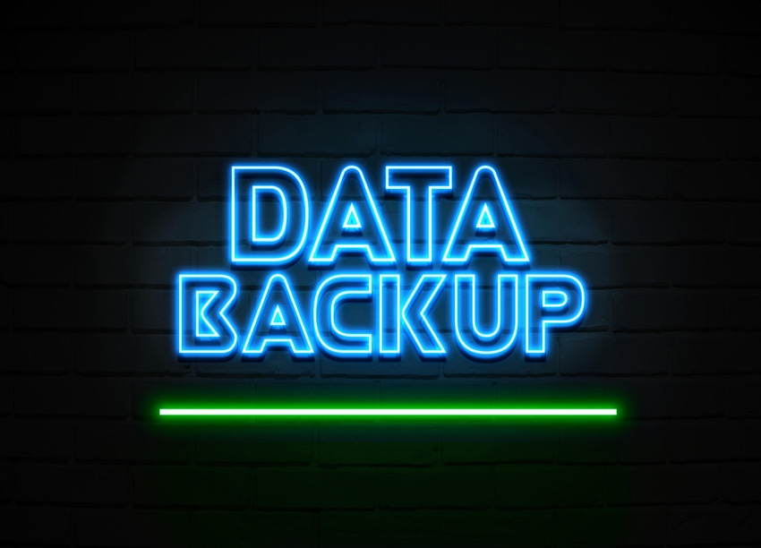glowing data backup neon sign on brick wall