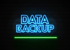 glowing data backup neon sign on brick wall glowing data backup neon sign on brick wall