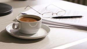 coffee with paper glasses and a pen in background