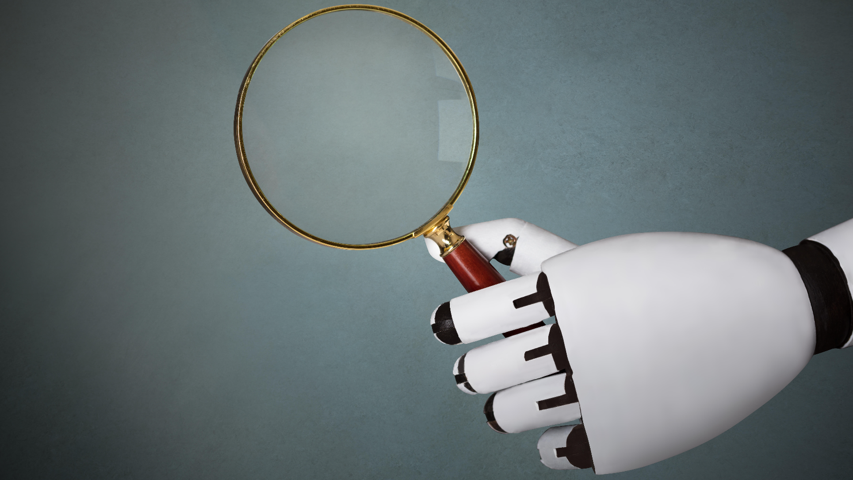 close-up of robot's hand holding magnifying glass