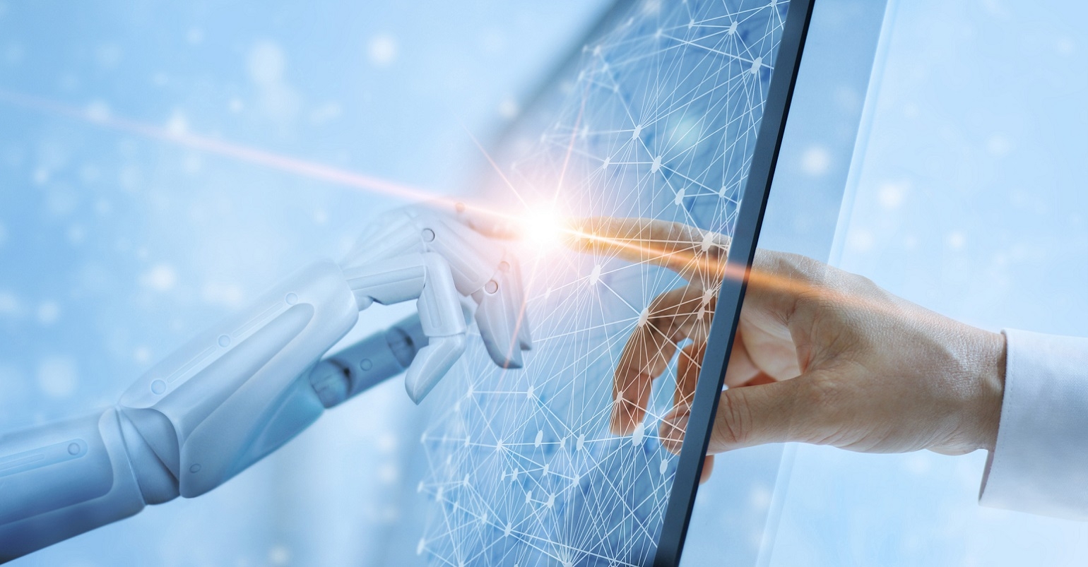 human hand and robot hand touching computer screen
