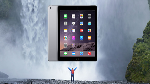 A composed image shows a larger than life iPad in front of a waterfall and above a man with his arms stretched out