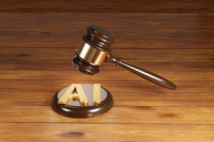 Wooden gavel with brass engraving band and golden AI letter on a round wood sound block