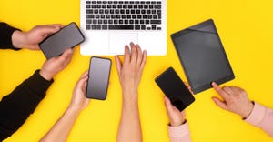 smartphones around a laptop smartphones around a laptop