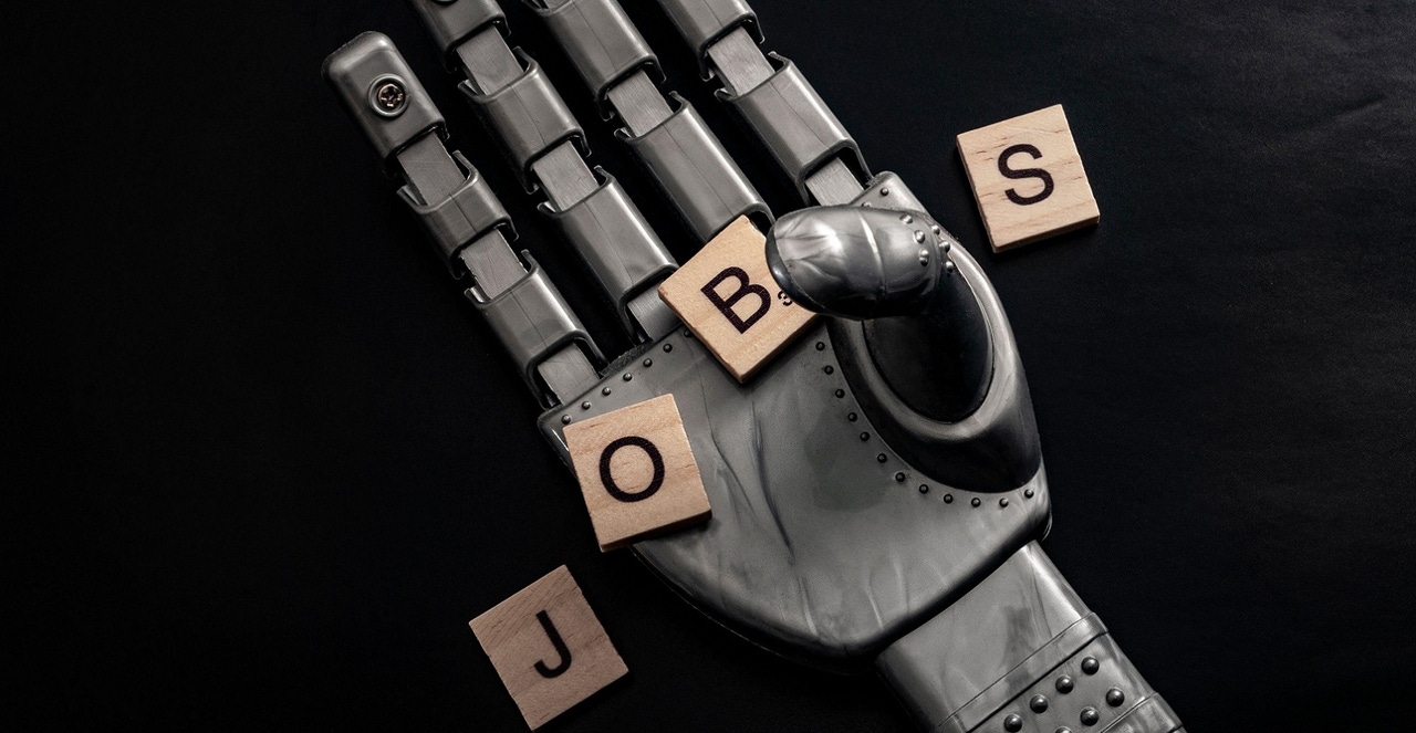 tiles spelling "jobs" being held by a robot tiles spelling "jobs" being held by a robot