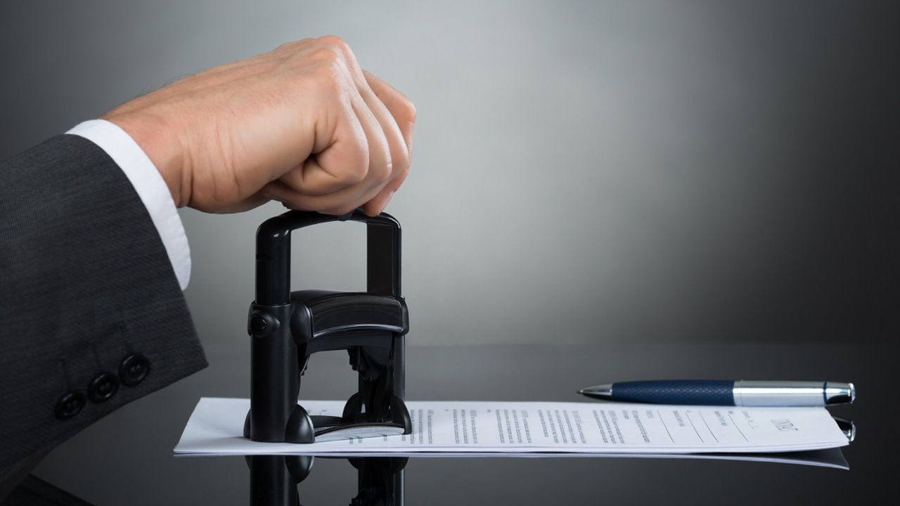 business person stamping a document business person stamping a document