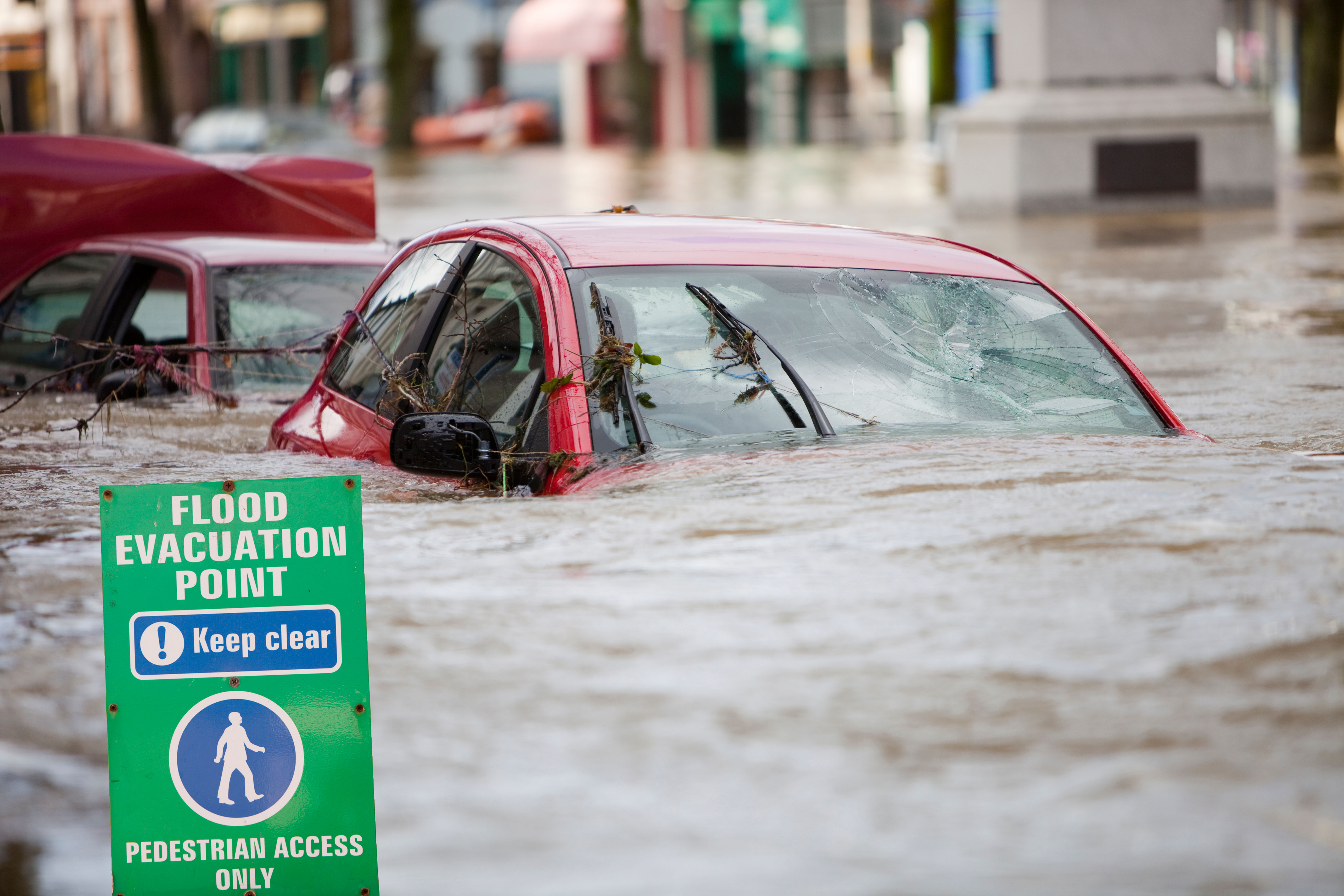 Flooded street with cars submerged in water