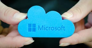 person holding a blue cloud with Microsoft Cloud written on it