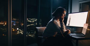 employee working on computer in the evening employee working on computer in the evening