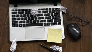 Laptop with Help sticky note