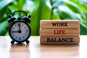 Alarm clock pointing at 9am with work life balance text on wooden blocks Alarm clock pointing at 9am with work life balance text on wooden blocks