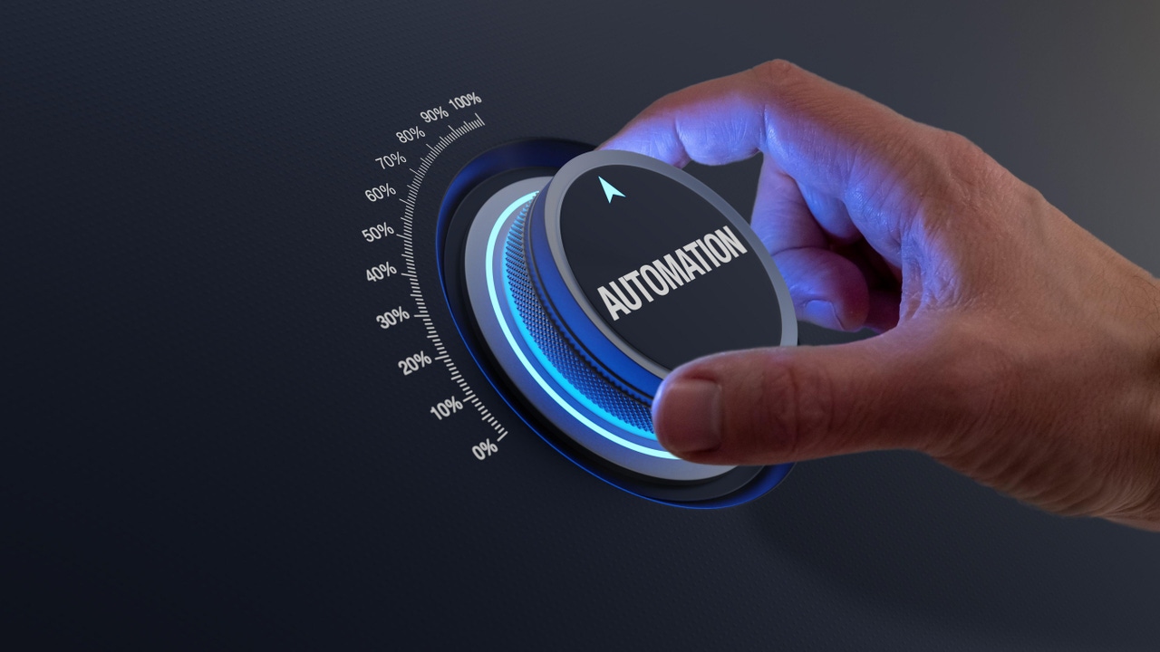 Person turning a dial labeled Automation Person turning a dial labeled Automation