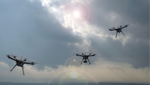 three drones flying in the sky
