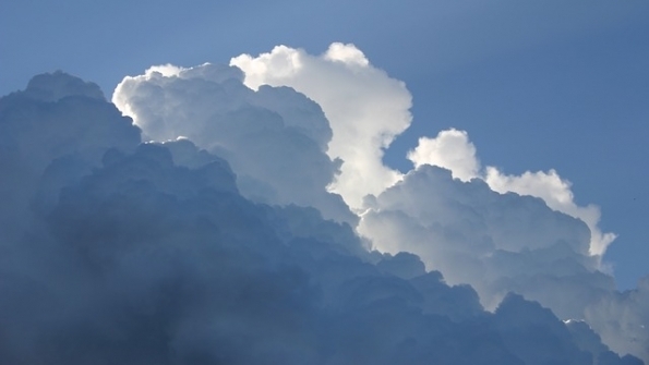 gathering clouds in blue sky