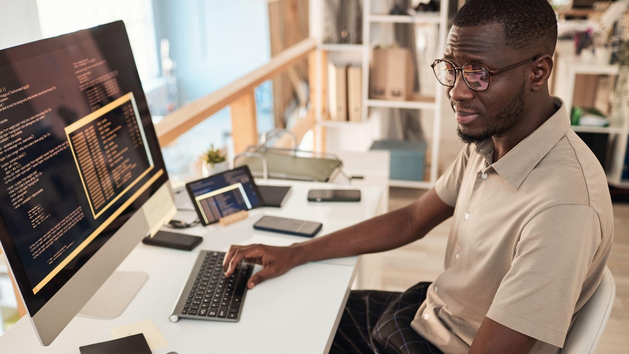 software developer working at his workstation software developer working at his workstation