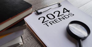 2024 trends and magnifying glass on pad of paper 2024 trends and magnifying glass on pad of paper