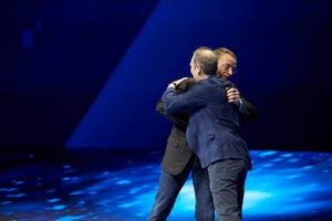 VMware CEO Pat Gelsinger and AWS CEO Andy Jassy hug on stage at VMworld 2018 in Las Vegas