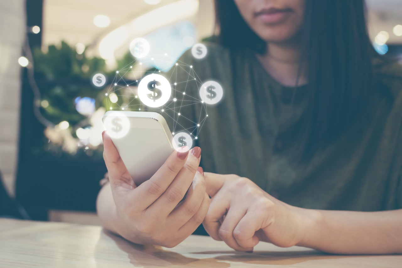 woman using phone to make mobile payments woman using phone to make mobile payments