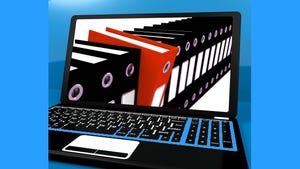 laptop screen showing a line of black folders with one red folder