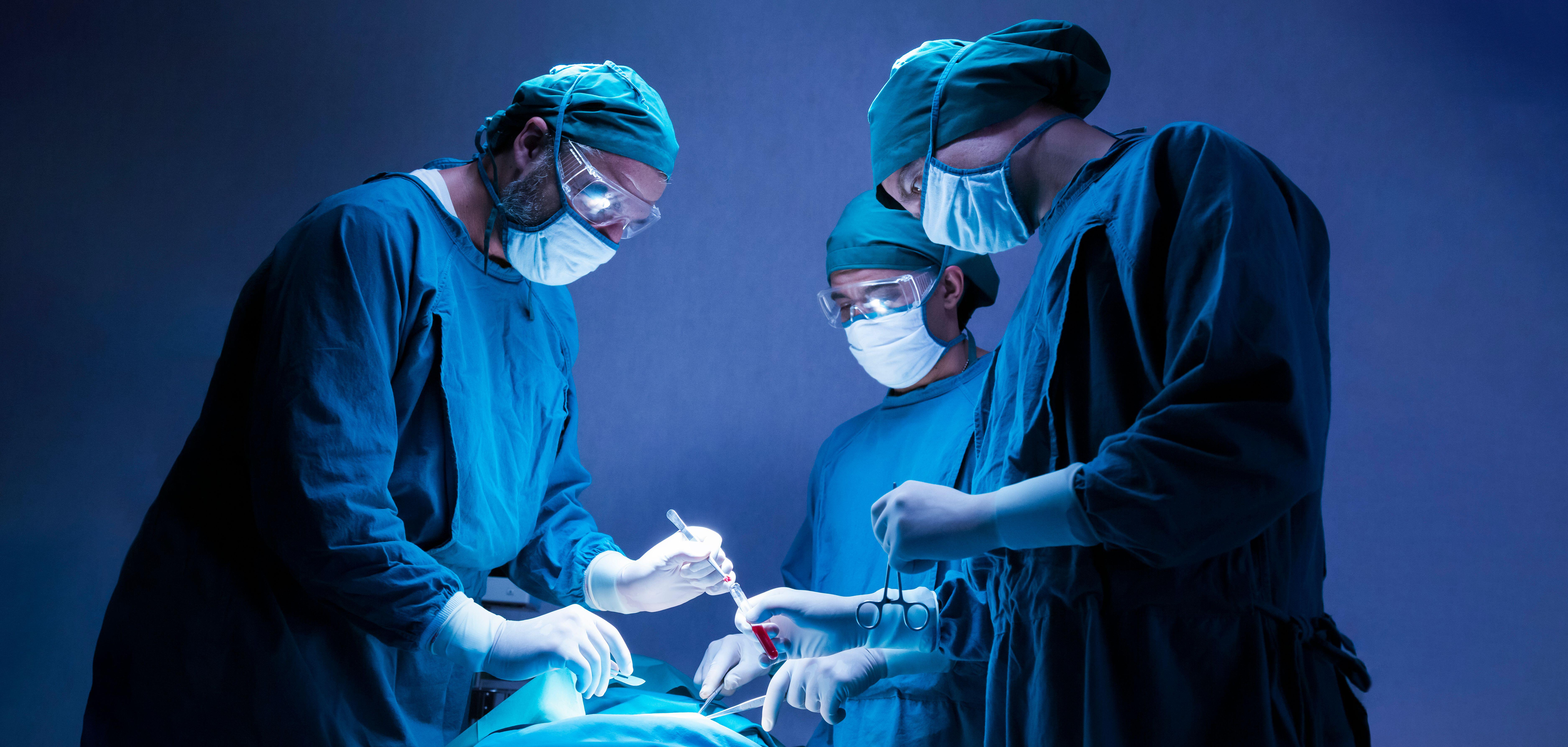 concentrated professional surgical doctor team operating surgery a patient