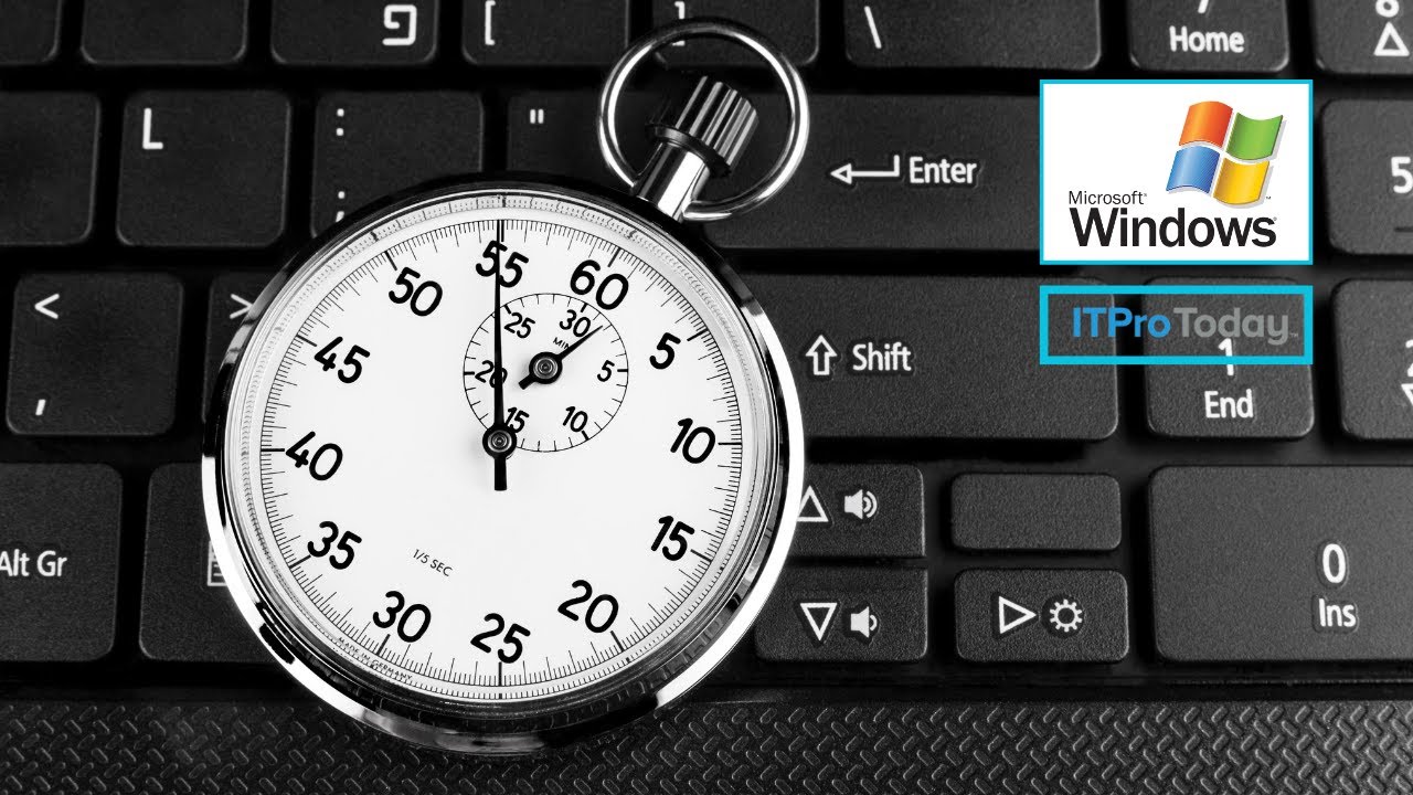 silver stopwatch on top of laptop keyboard