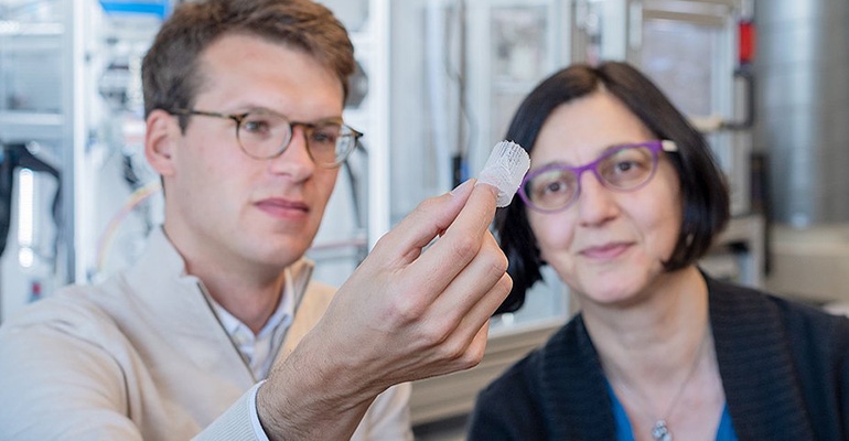 researchers examining artificial heart valve