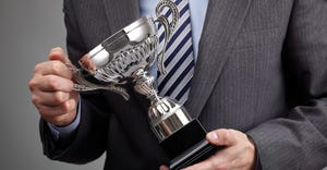 businessman holding trophy