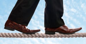 businessman walking tightrope