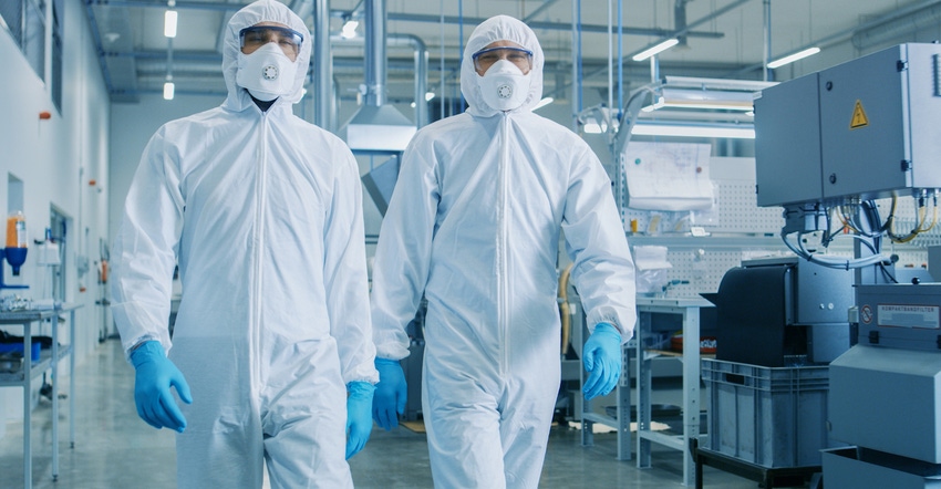 workers suited up in a cleanroom environment
