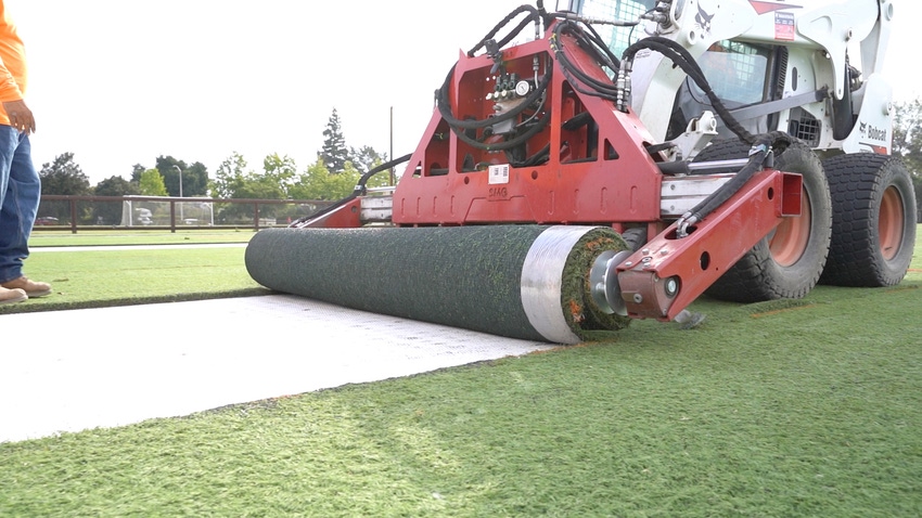 rolling out artificial turf